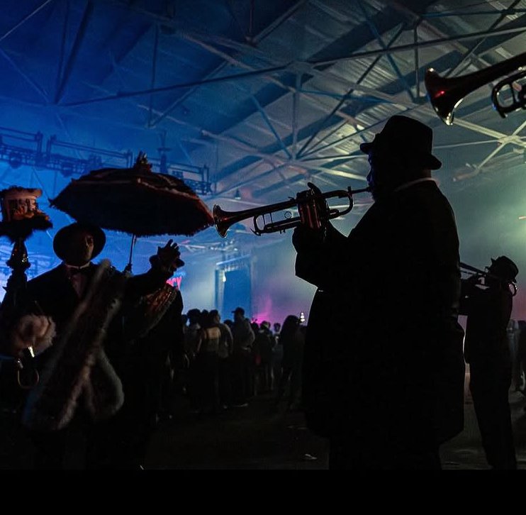 New Orleans brass band performing under stage lights
